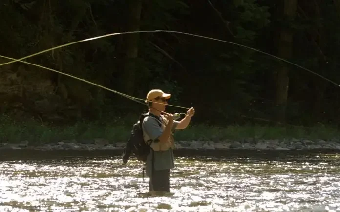 A man fishes in the St. Joe River in northern Idaho.